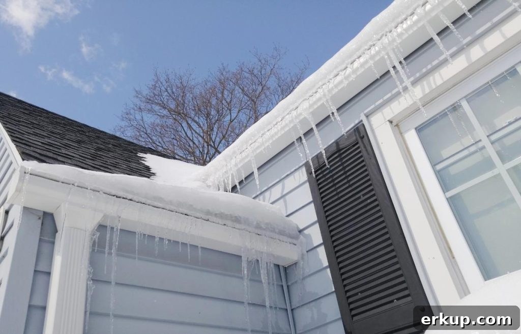 icicles hanging off the roof of a gray house