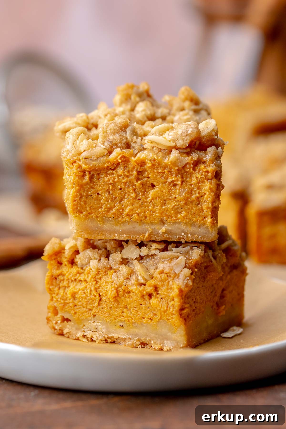 Pumpkin Pie Bars with Buttery Shortbread Crust 11 A stack of two pumpkin pie bars.
