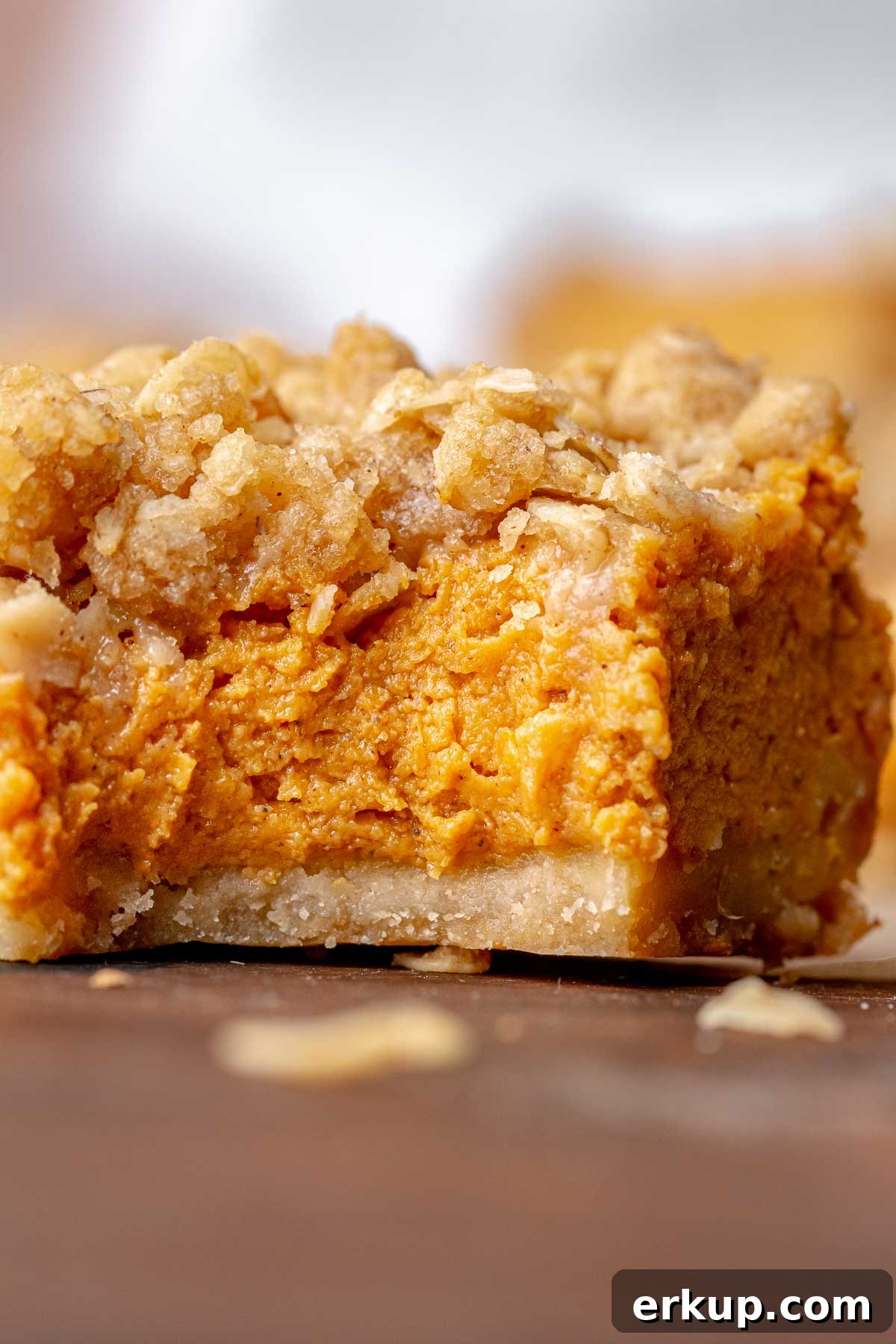 Pumpkin Pie Bars with Buttery Shortbread Crust 13 A pumpkin pie bar with a bite removed.