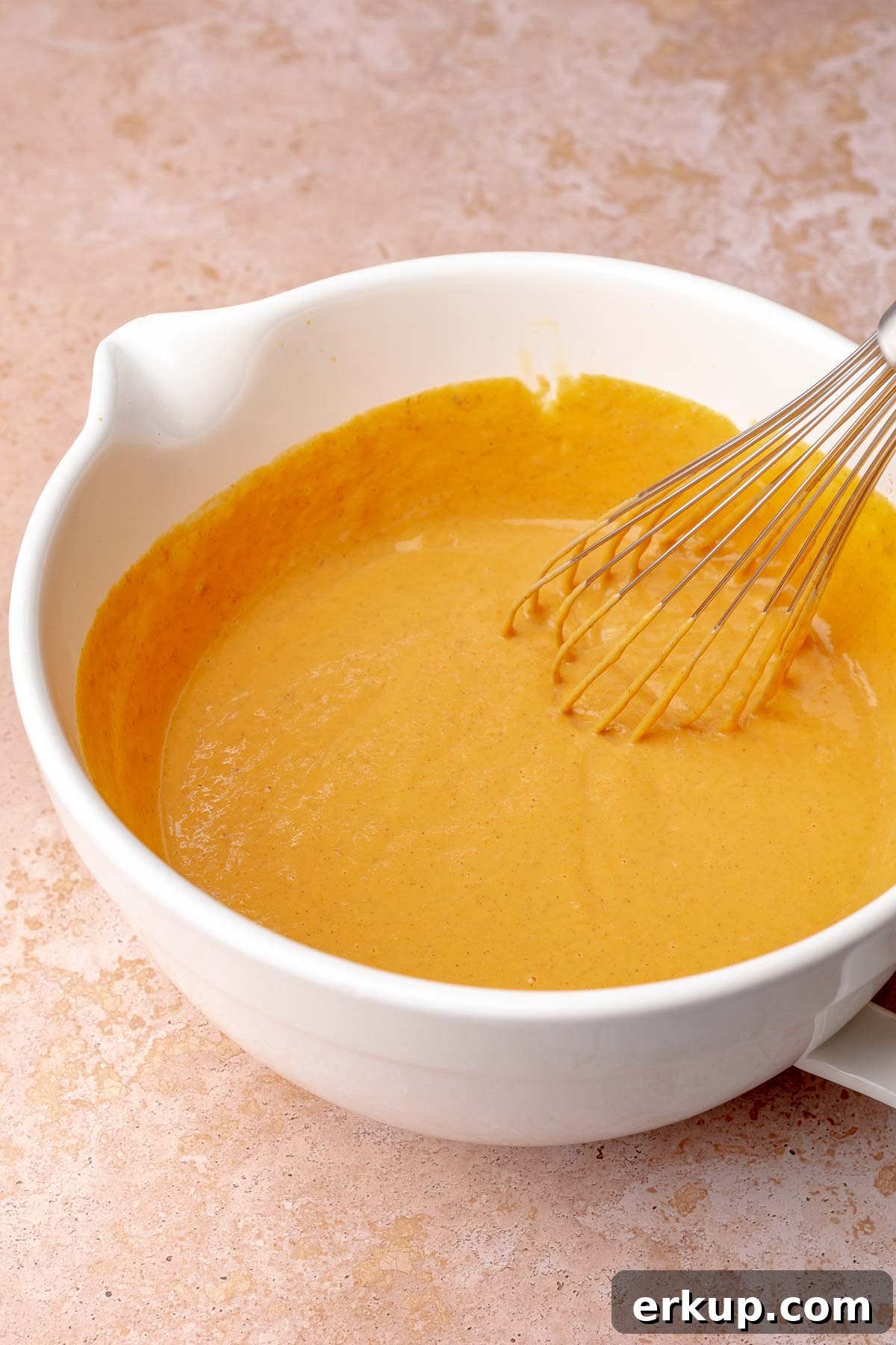 Pumpkin Pie Bars with Buttery Shortbread Crust 7 Pumpkin pie filling being whisked in a bowl.