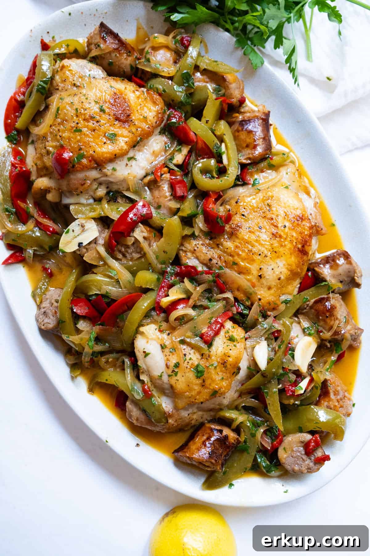 chicken scarpariello sitting on a plate with its braised juices
