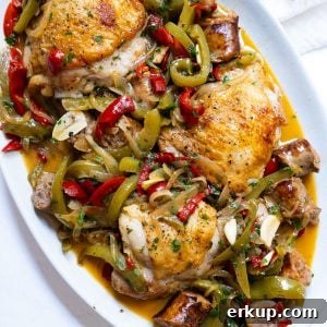 chicken scarpariello sitting on a plate with its braised juices