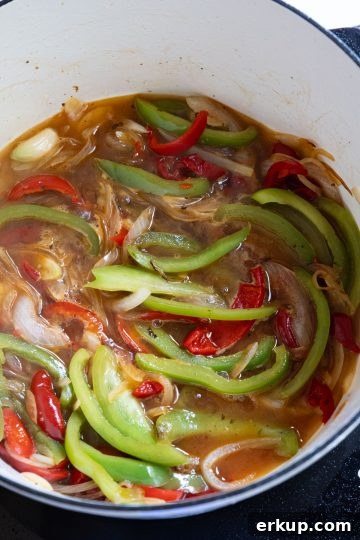 peppers and sauce simmering in white wine sauce