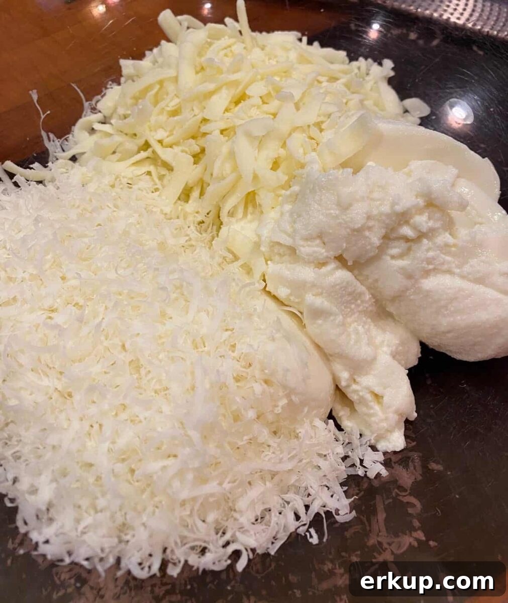 Creamy Cheesy Baked Ziti Casserole Recipe 4 Mozzarella, parmesan and ricotta cheese in a large bowl.