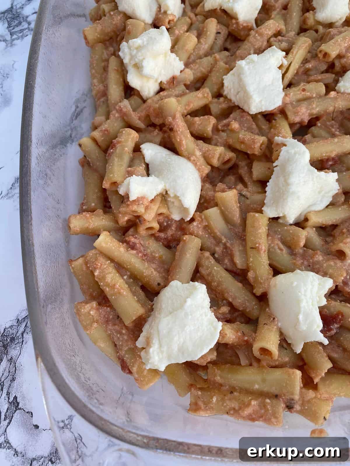 Creamy Cheesy Baked Ziti Casserole Recipe 6 Ziti pasta in a baking dish with cheese.