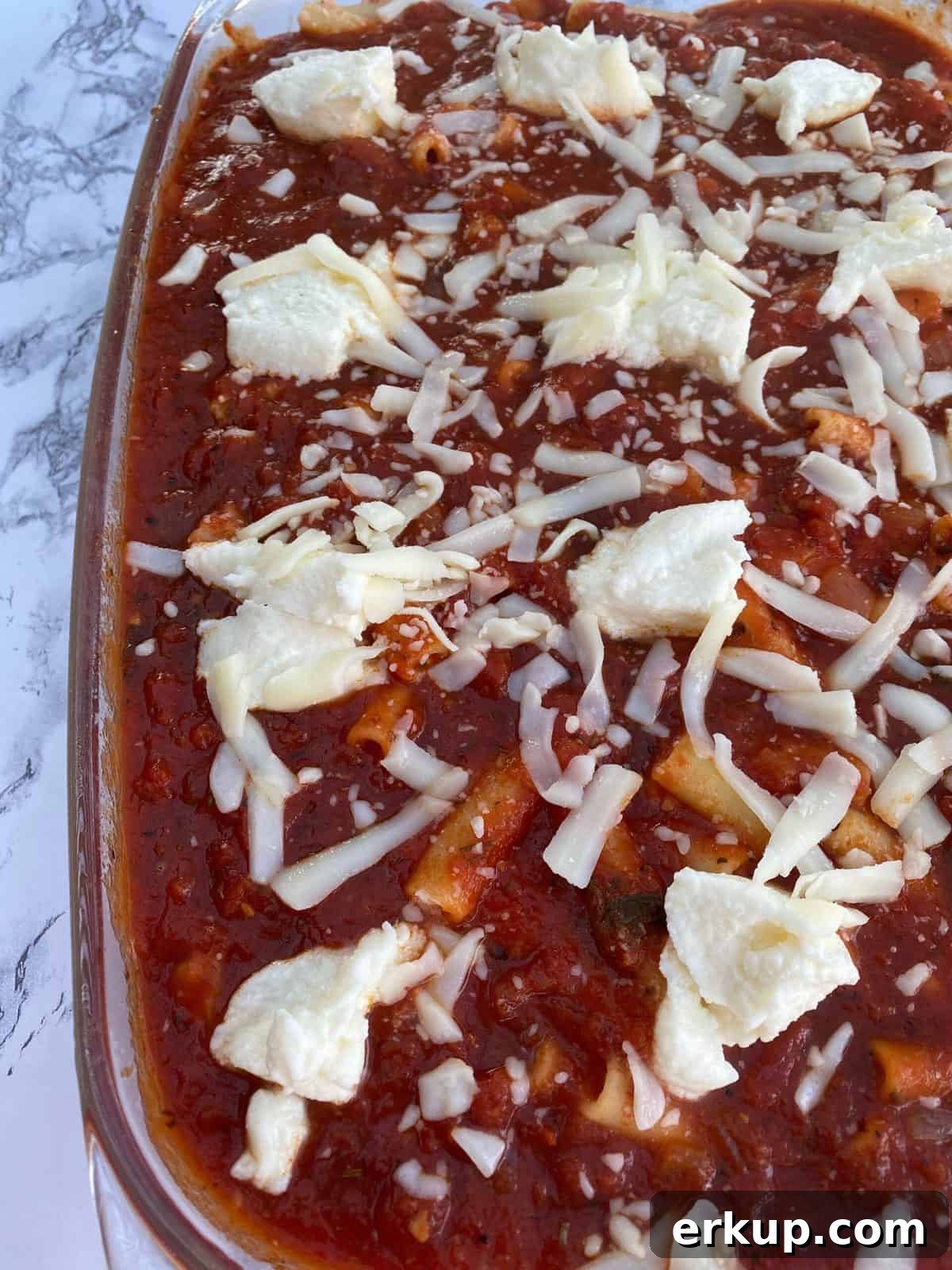 Creamy Cheesy Baked Ziti Casserole Recipe 7 Ziti casserole with sauce on top and cheese.