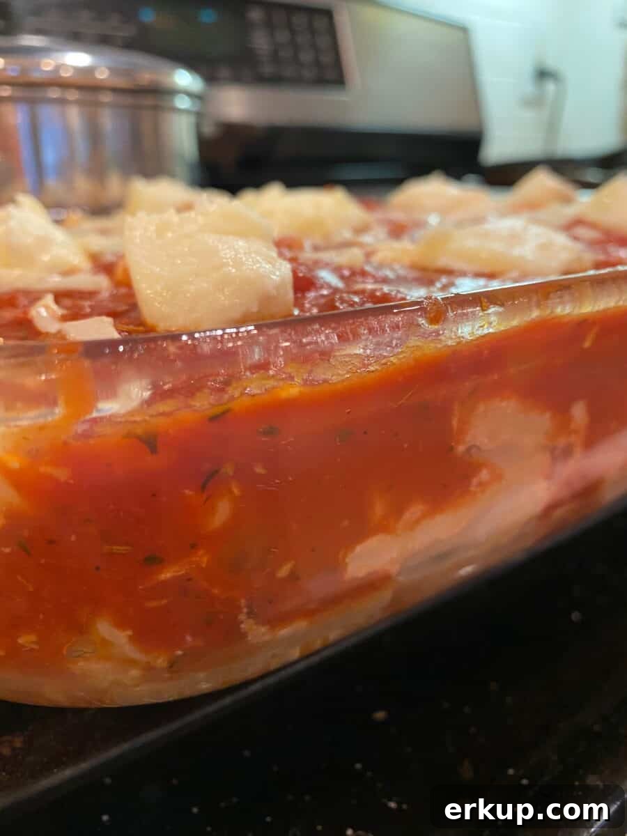 Creamy Cheesy Baked Ziti Casserole Recipe 8 Cheesy Baked Ziti in a baking dish, on a stovetop.