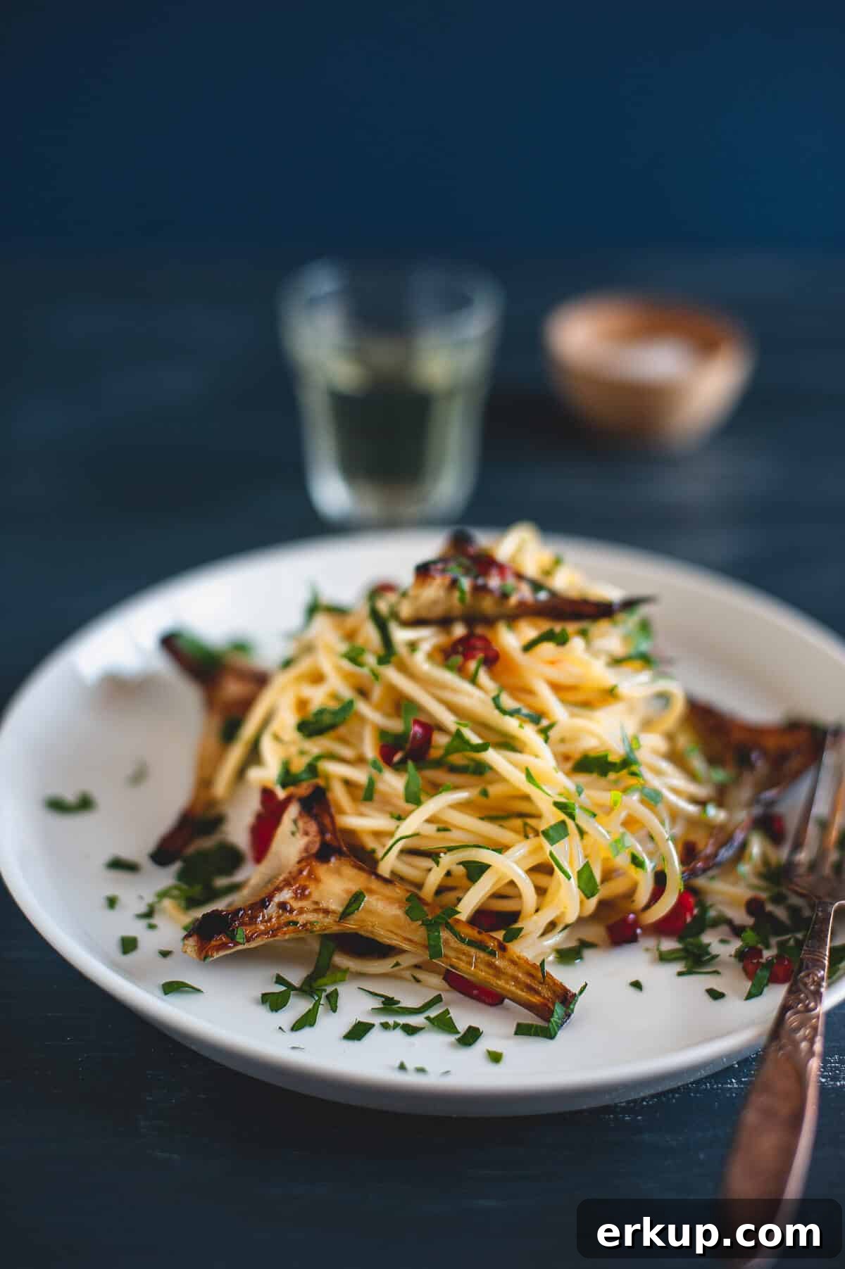 artichokes with spaghetti served on a plate
