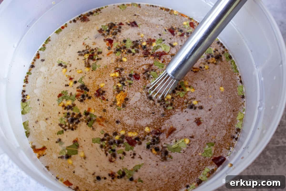 Looking down into a bucket filled with water and spices.