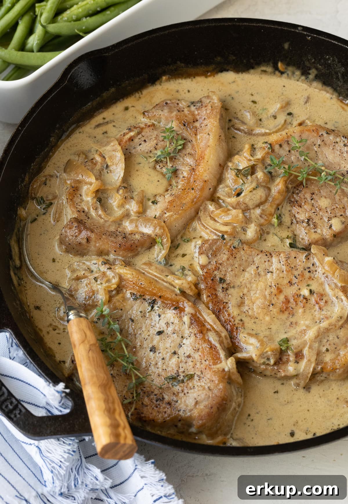 Sour crem pork chops in cast iron skillet.