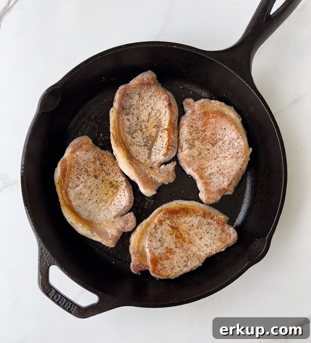 Browned pork chops in cast iron.