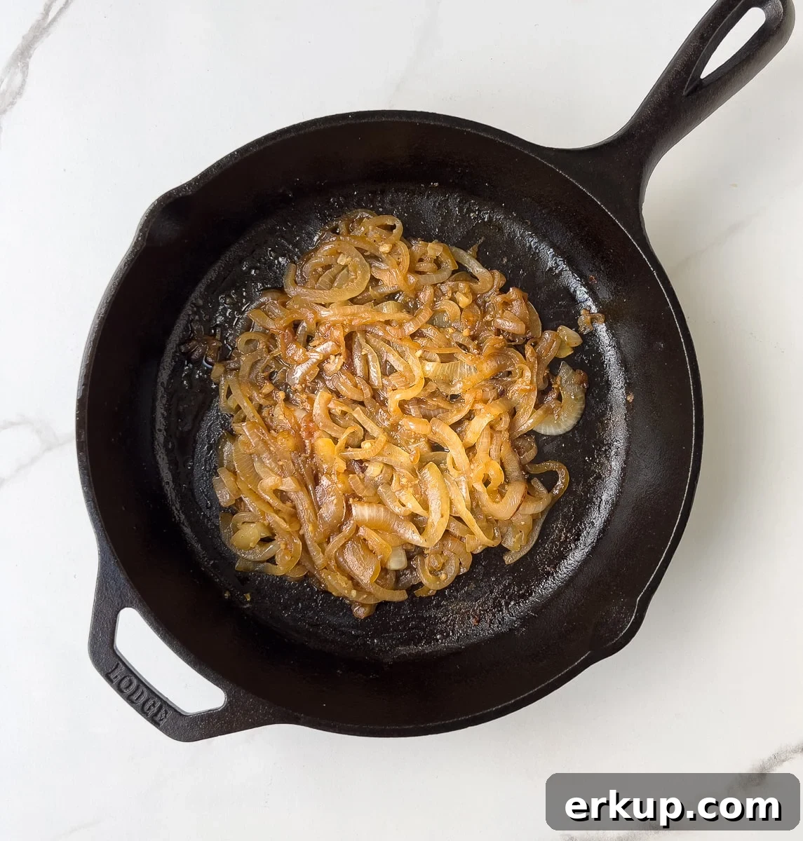 Caramelized onions in black pan.