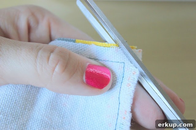 DIY Reversible Placemat: Step-by-Step Sewing Tutorial 10 scissors cutting corner of fabric