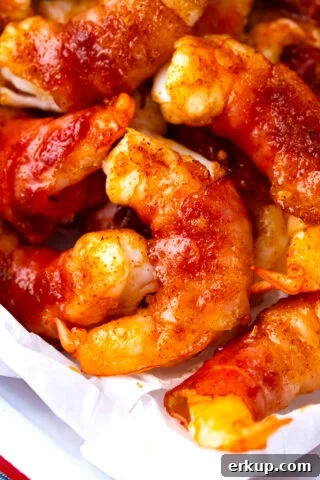 Close shot of bacon wrapped shrimp with brown sugar on a tray.