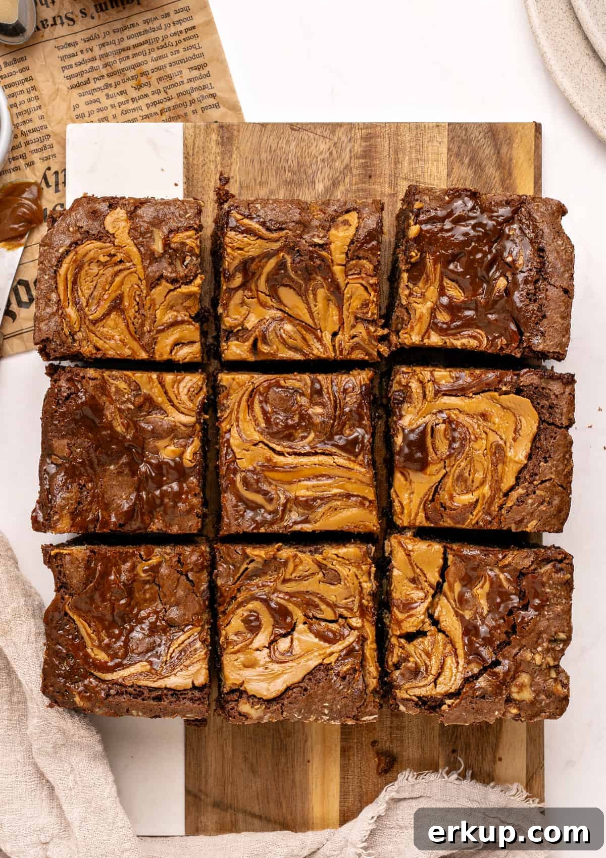 Nine squares of kitchen sink brownies on a wooden board. Top view.