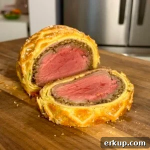 Holiday Beef Wellington Recipe to Impress Guests 5 Sliced beef Wellington on wooden board