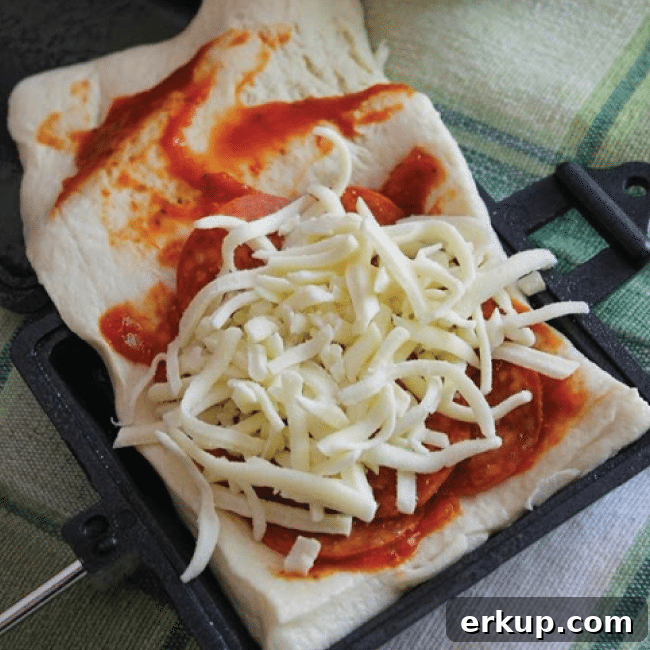 25+ Campfire Recipes and Camping Hacks to Try 11 Camp Cooker Pizza from Twin Dragonly Designs
