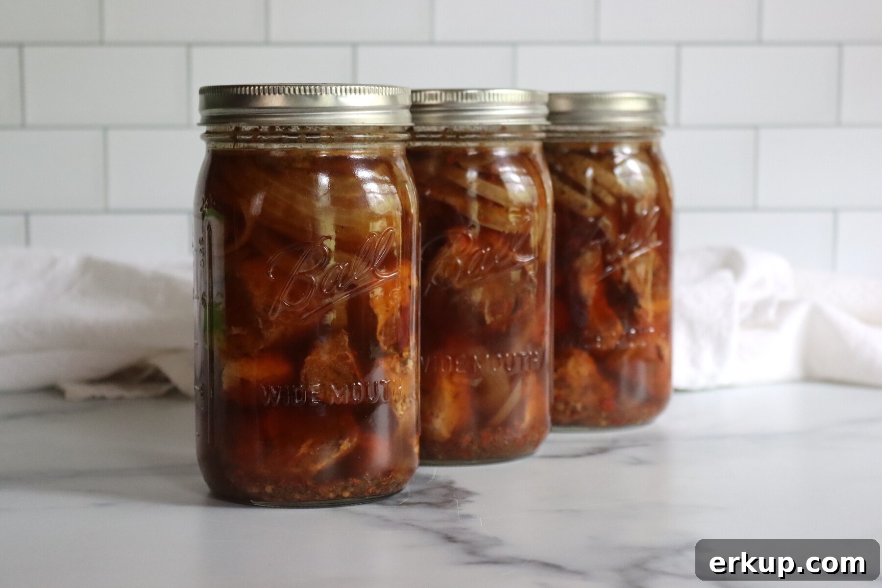 Three Jars of Ball Canning's recipe for roast pork in spicy broth.