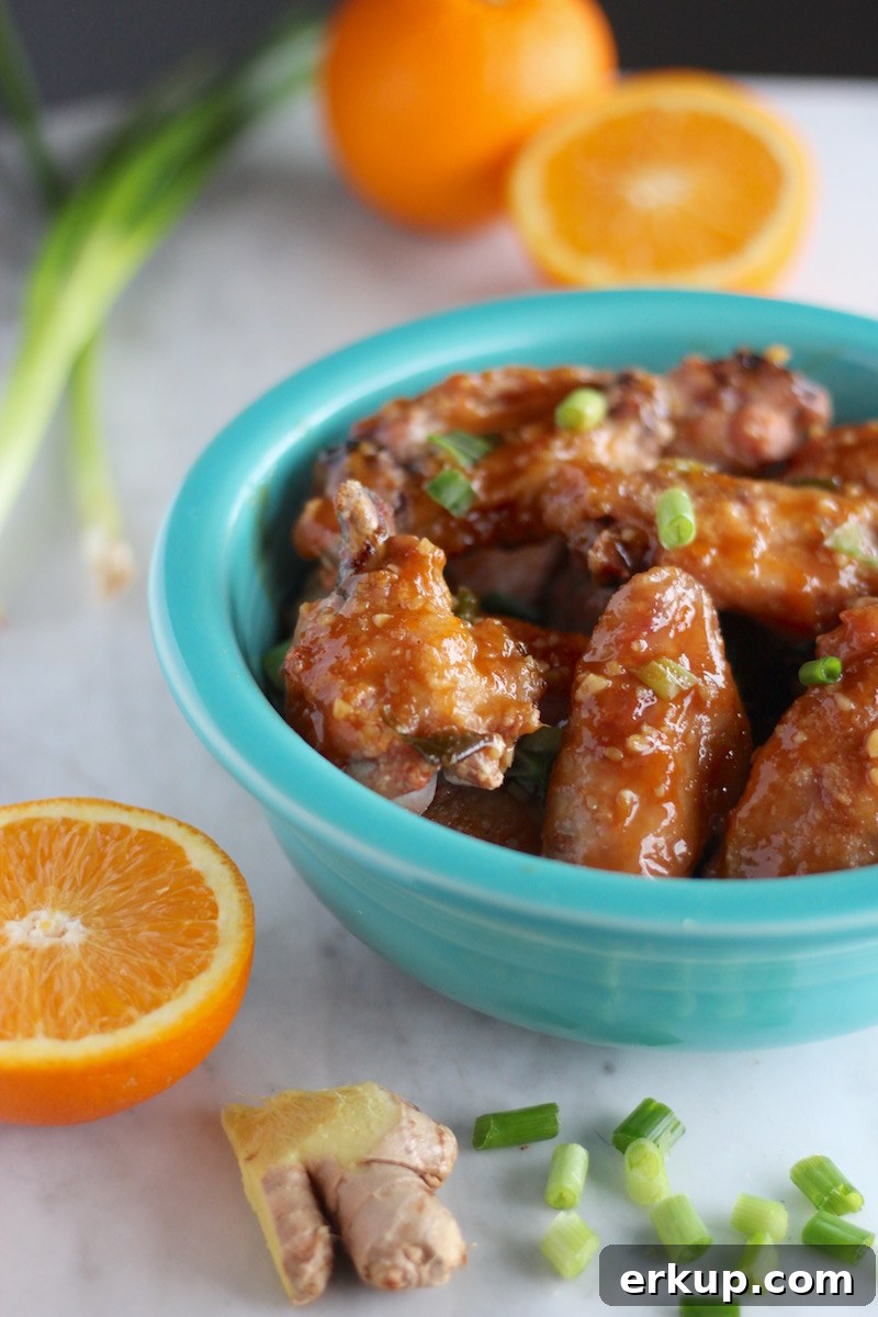 Sweet and Sticky Orange Ginger Wings (AIP) - these insanely flavorful Paleo chicken wings are created with an Asian-inspired orange, ginger, and garlic sauce that will have you licking your fingers! YUM! | fedandfulfilled.com