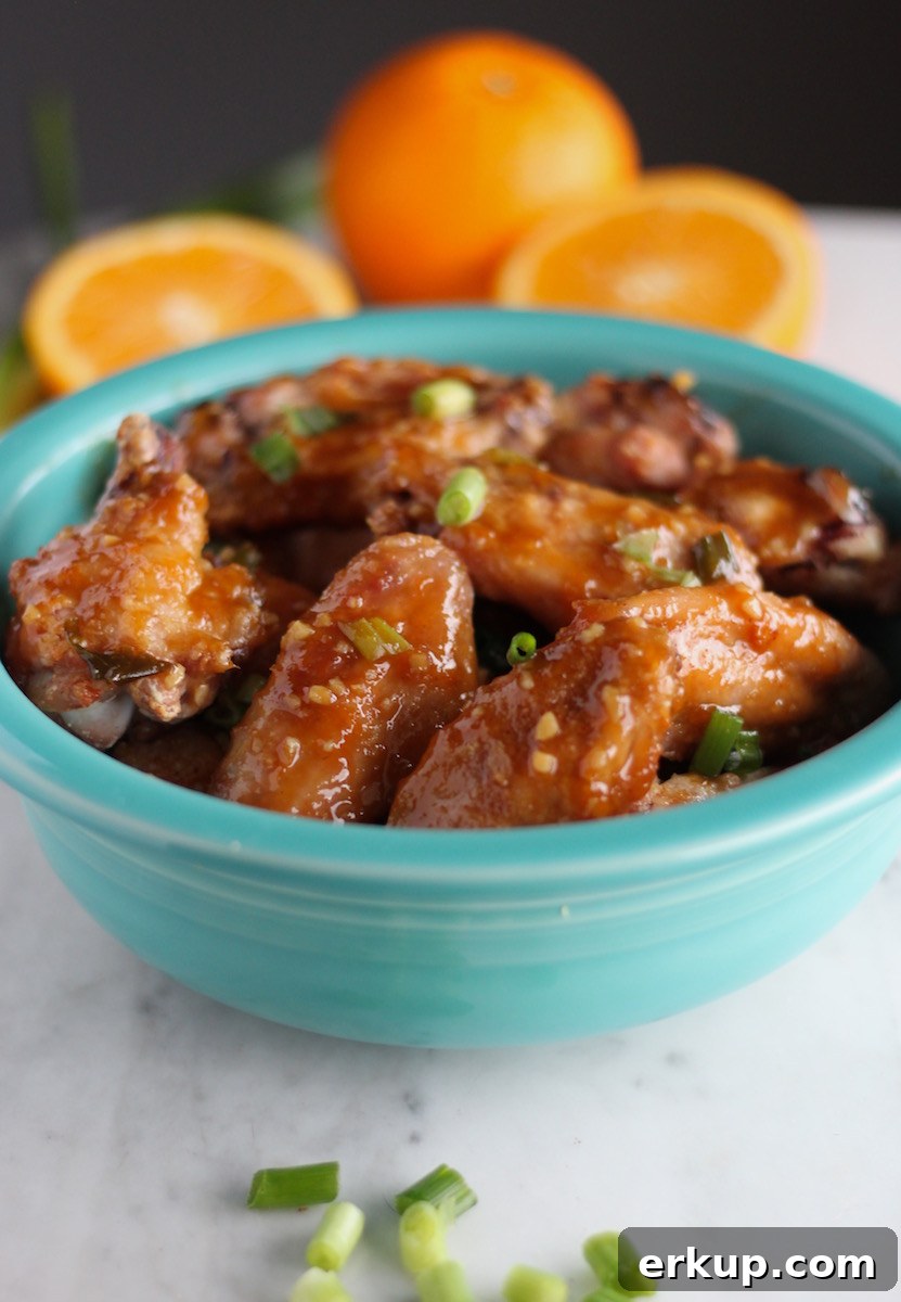 Sweet and Sticky Orange Ginger Wings (AIP) - these Paleo chicken wings are roasted until crisp, then slathered with orange ginger garlic sauce for a sticky, sweet finish! | fedandfulfilled.com