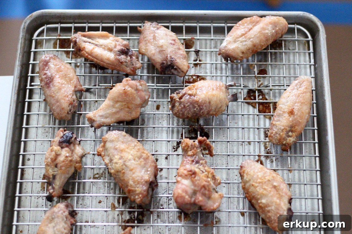 Sweet and Sticky Orange Ginger Wings (AIP) - crispy oven-baked chicken wings are drenched in a sweet and sticky orange ginger garlic sauce! Delish! | fedandfulfilled.com