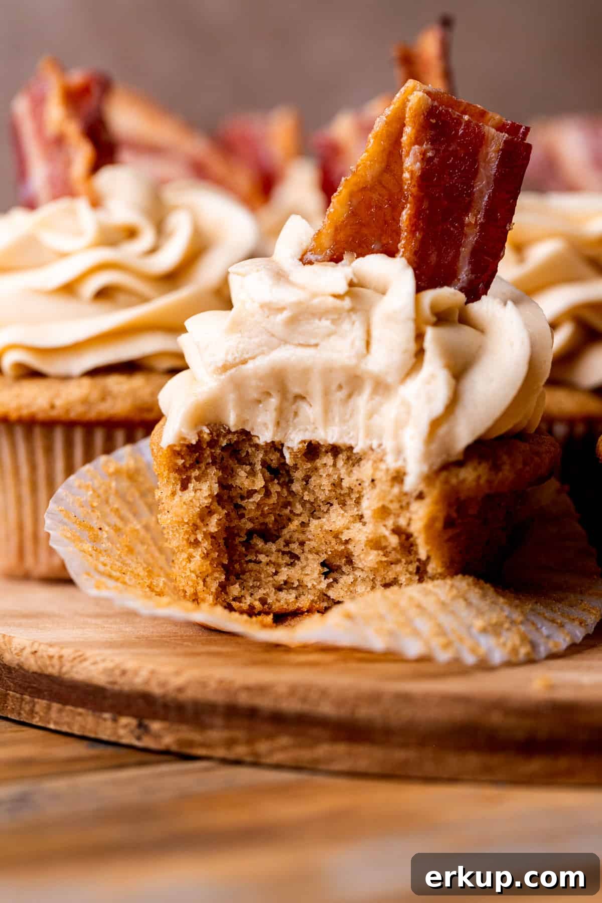 Maple Bacon Cupcakes with Candied Bacon 11 Close up of a bite missing from maple bacon cupcakes.