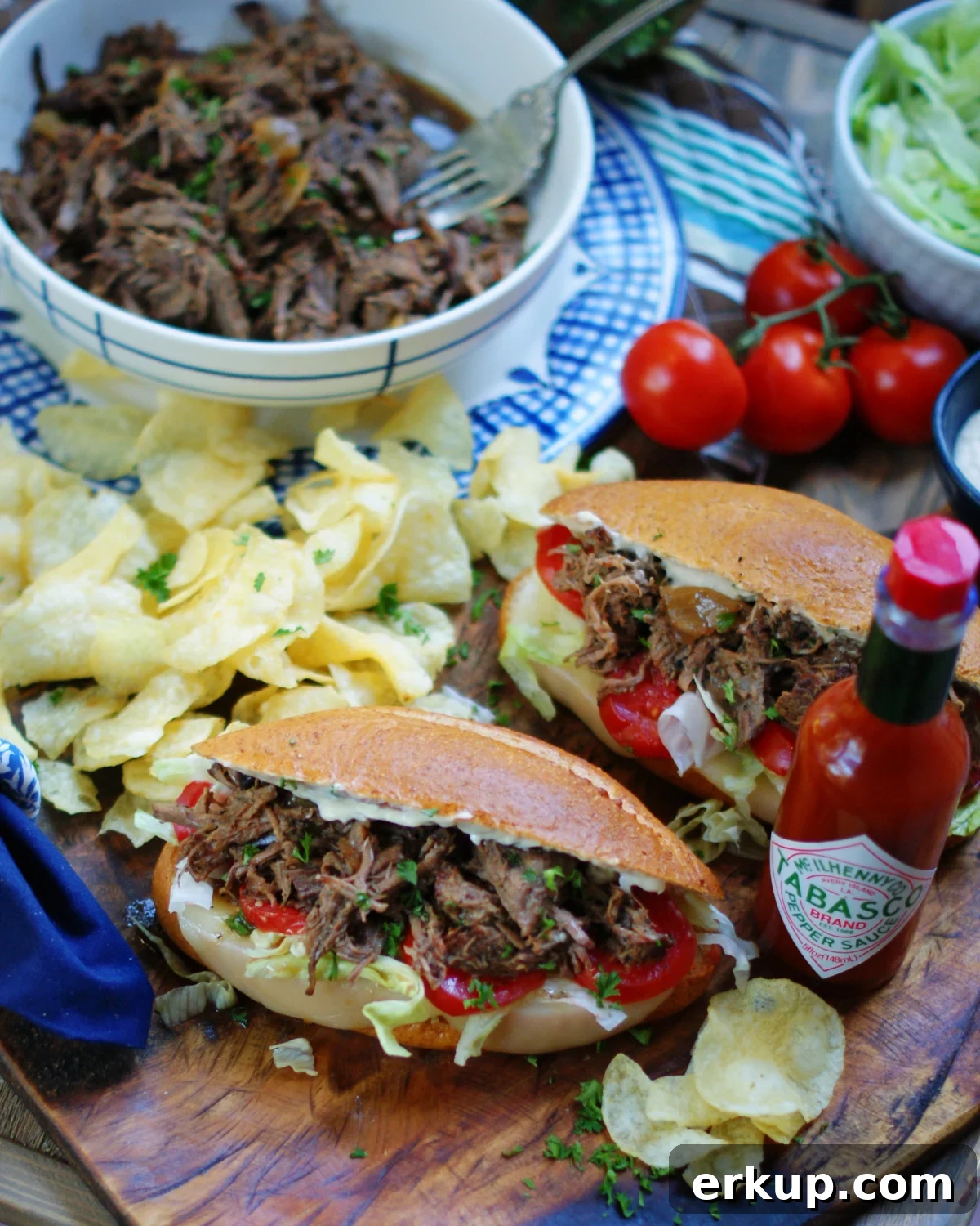 Serving Po Boy Sandwiches for game day with hot sauce and potato chips.