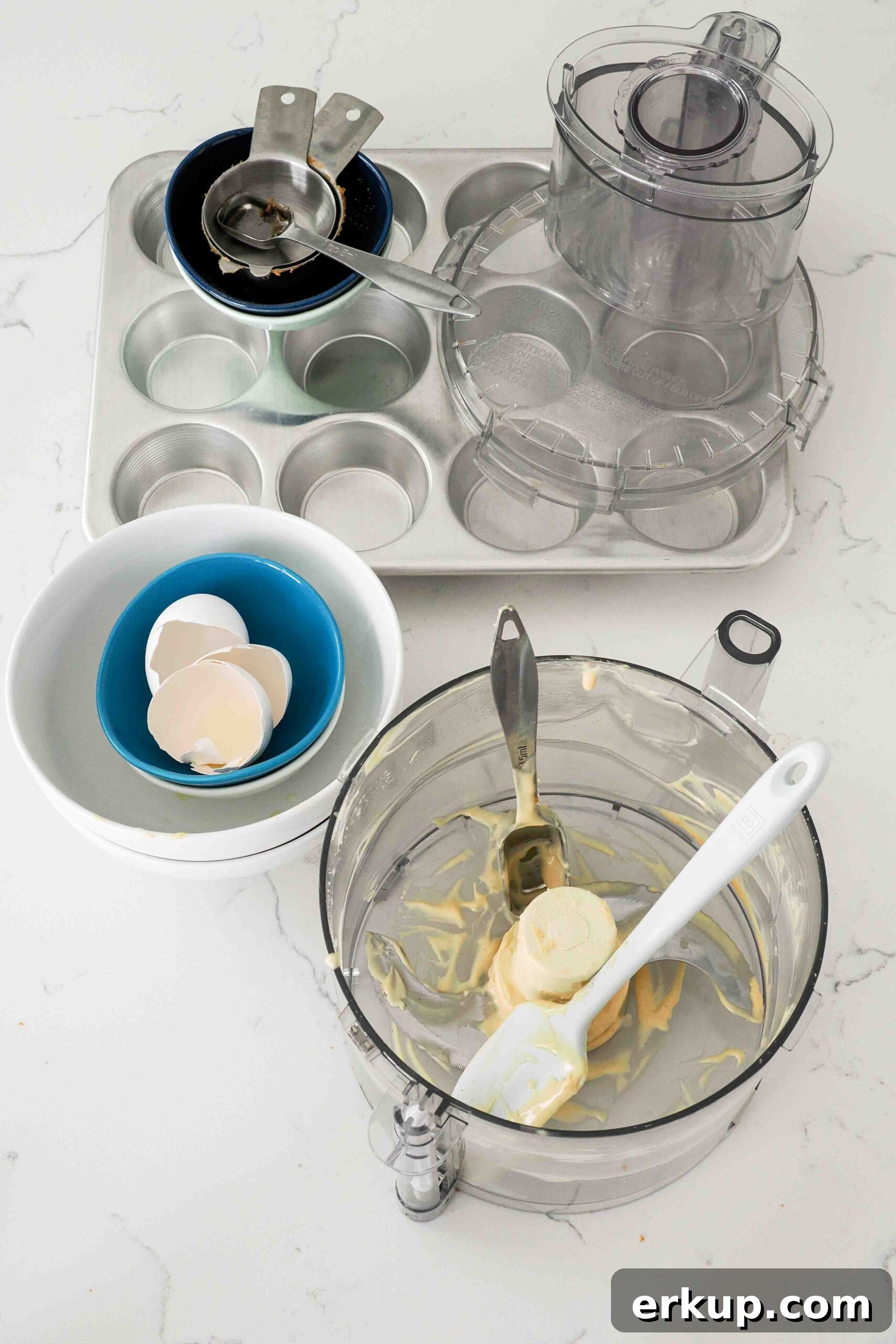 A collection of dishes used to make mini Biscoff cheesecakes.