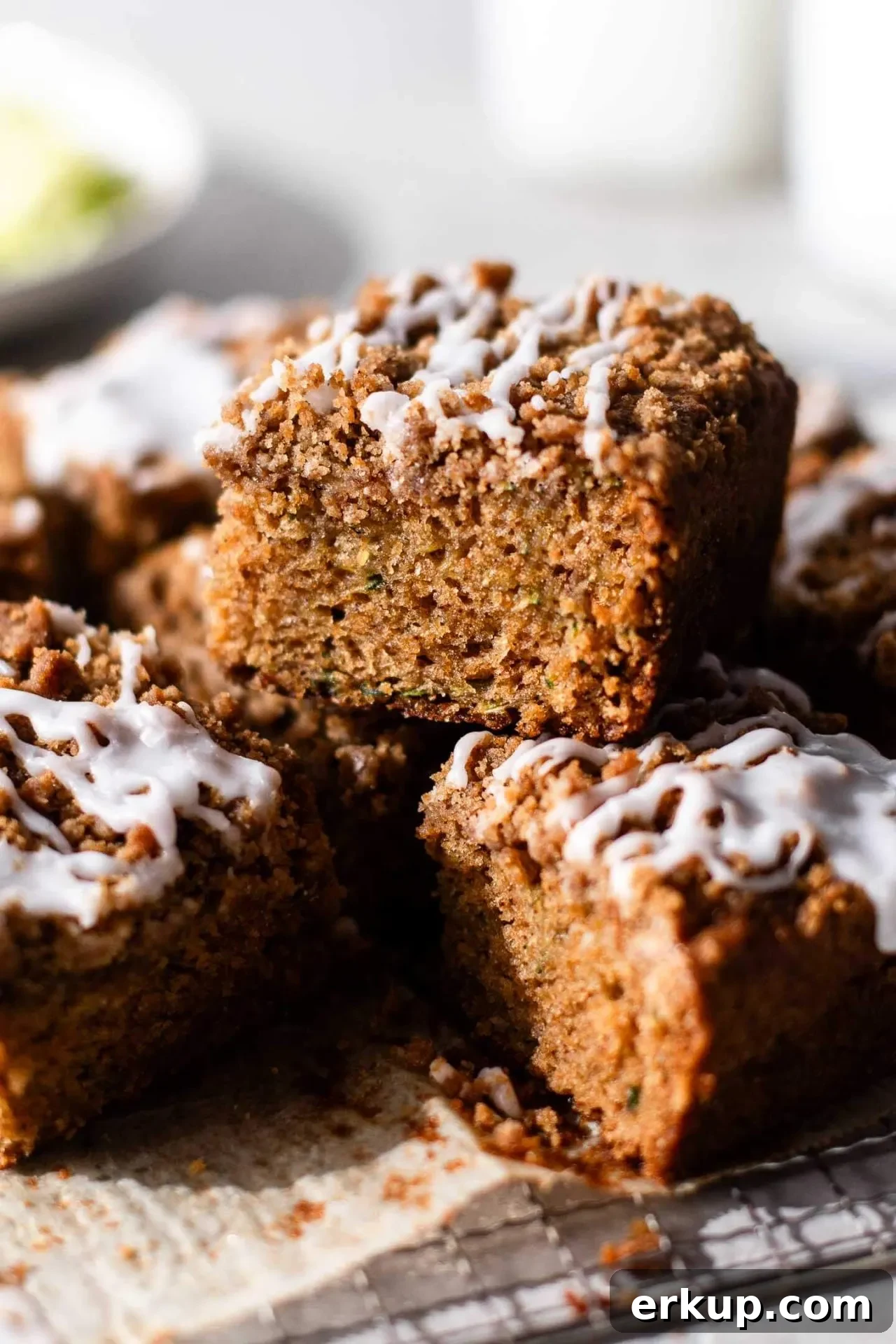 sliced sour cream zucchini coffee cake on parchment lined wire rack (1)