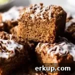 sliced sour cream zucchini coffee cake on parchment lined wire rack (1)
