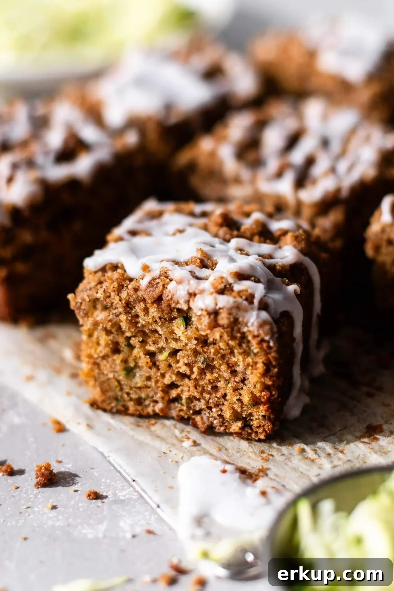 sliced sour cream zucchini coffee cake on parchment lined wire rack (4)