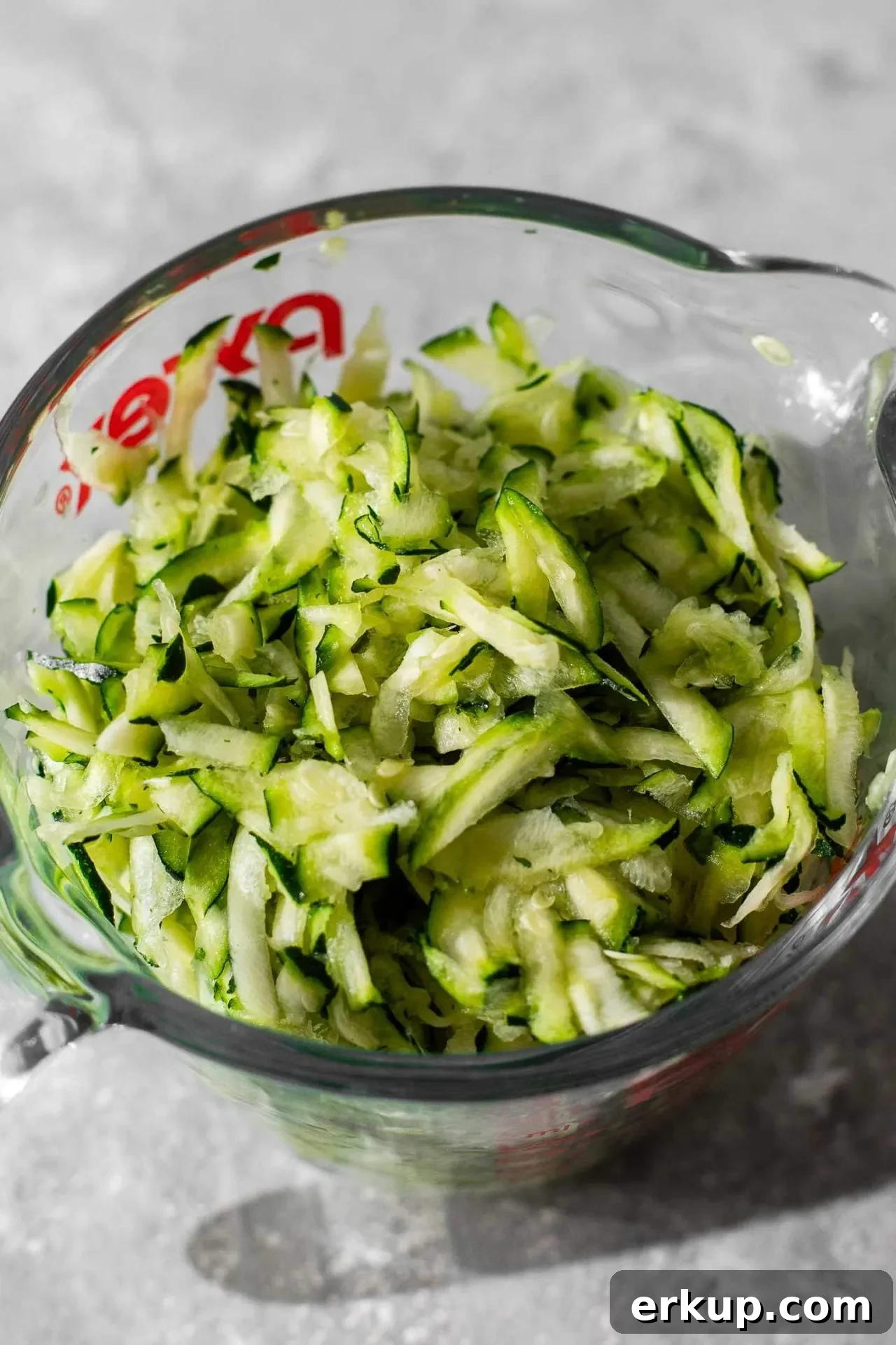 sour cream zucchini coffee cake shredded zucchini in glass measuring cup