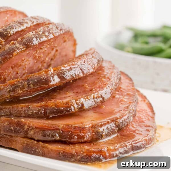 Crockpot ham sliced and on a platter.