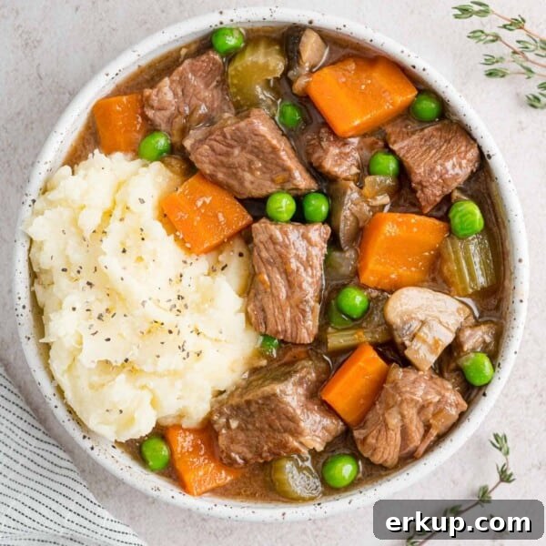Slow cooker beef marsala stew in a white bowl with potatoes.