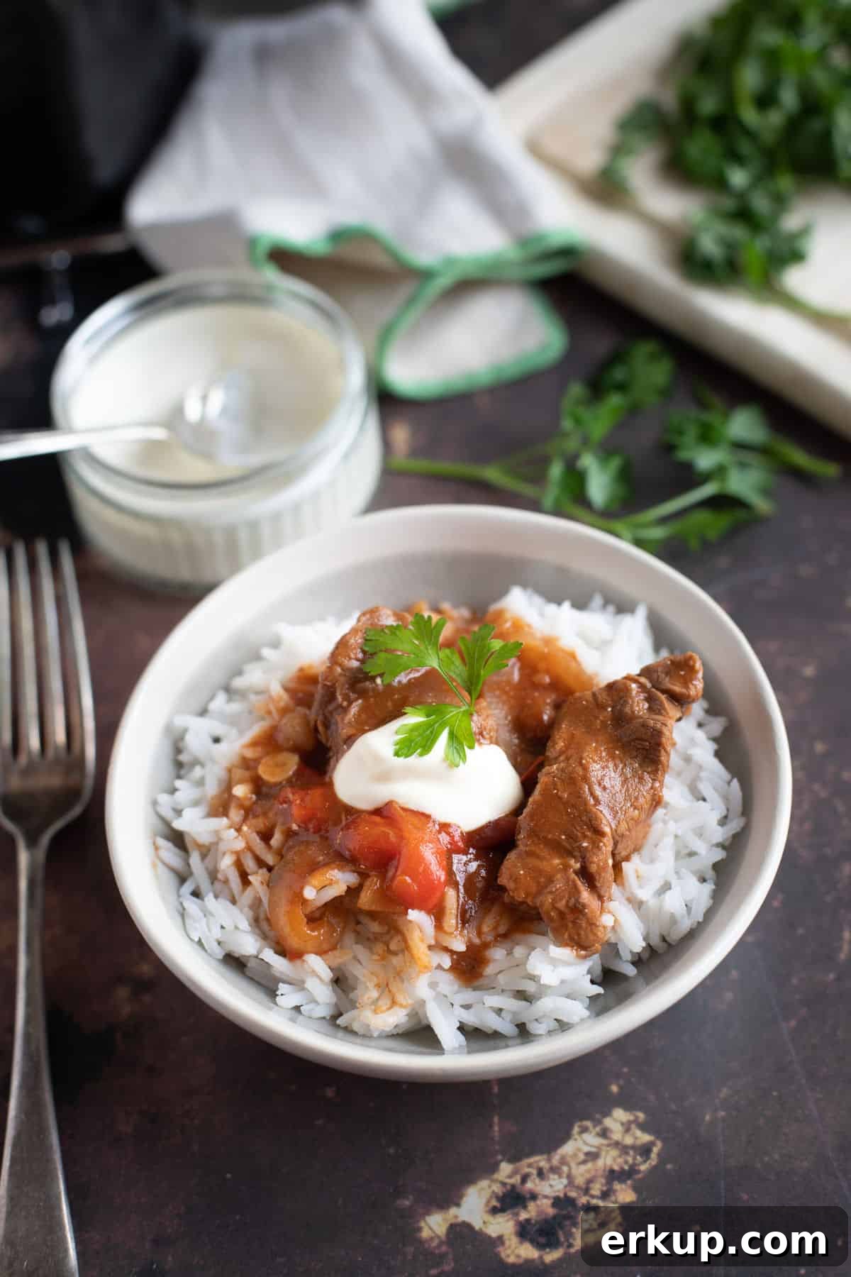 Slow Cooker Hungarian Beef Goulash with Paprika 4 Slow cooker beef goulash served on rice with soured cream and parsley.