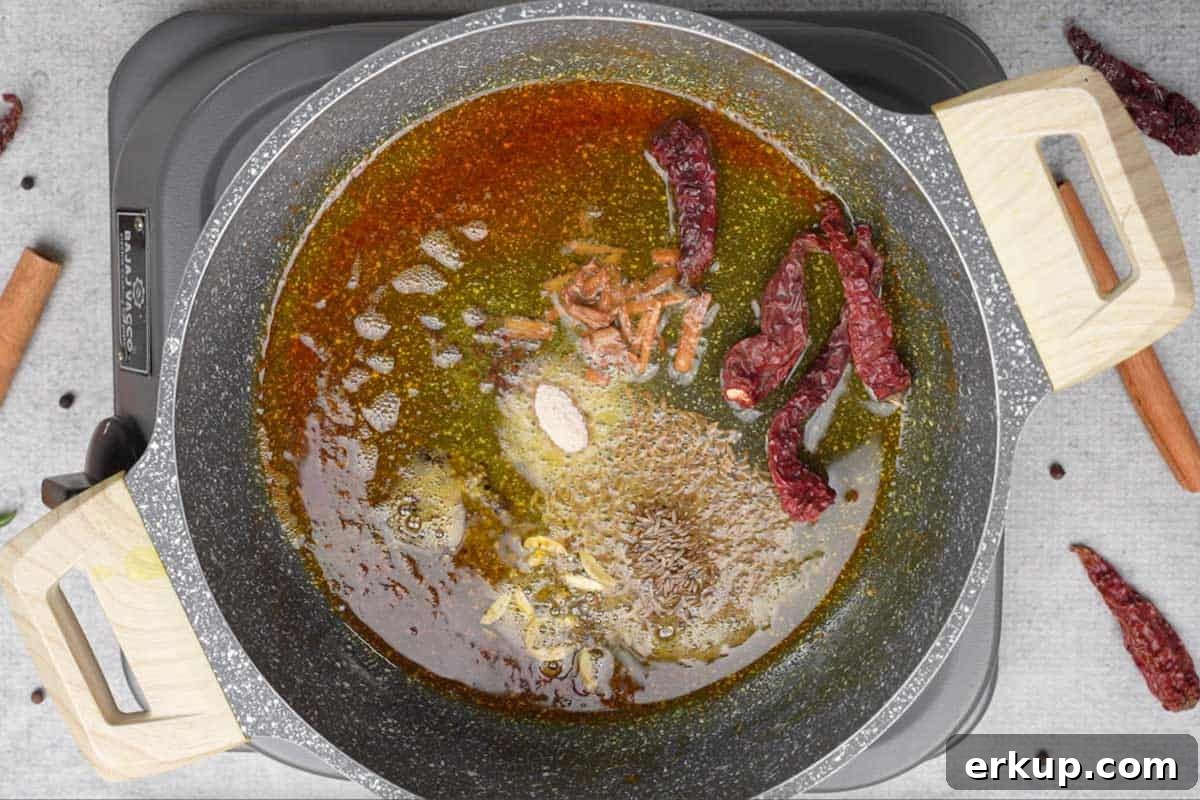 Whole spices added to the pan.