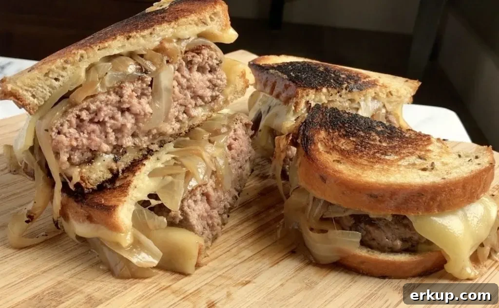Diner-Style Patty Melts, cut in half and stacked on cutting board.