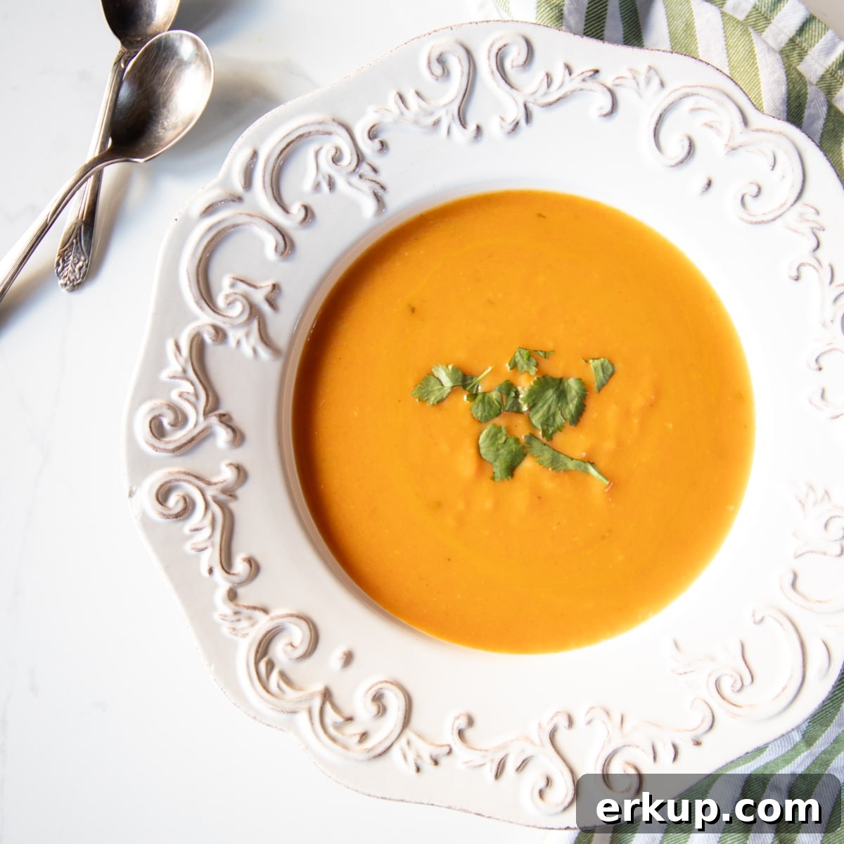 Week 5 Vegetarian Meal Plan for April 5 Bowl of carrot, coconut and ginger soup garnished with cilantro