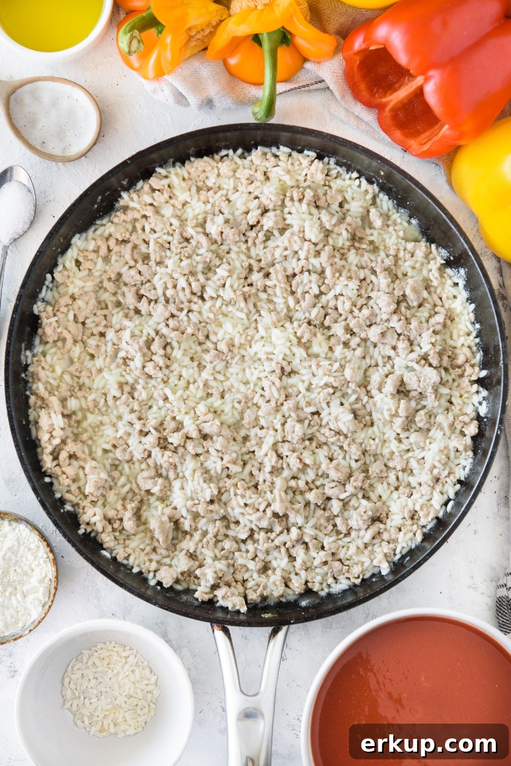 Old-Fashioned Stuffed Bell Peppers Recipe 6 A skillet filled with cooked ground meat and cooked rice.