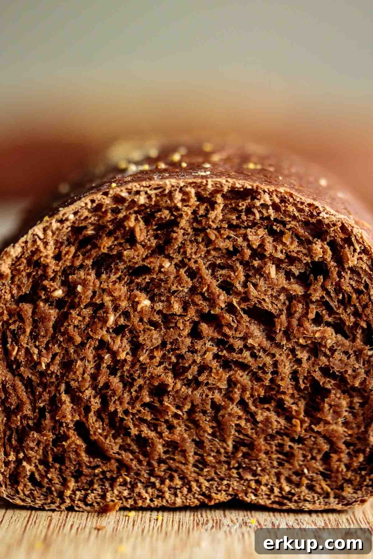 Close up showing chewy brown crumb of a sliced roll.