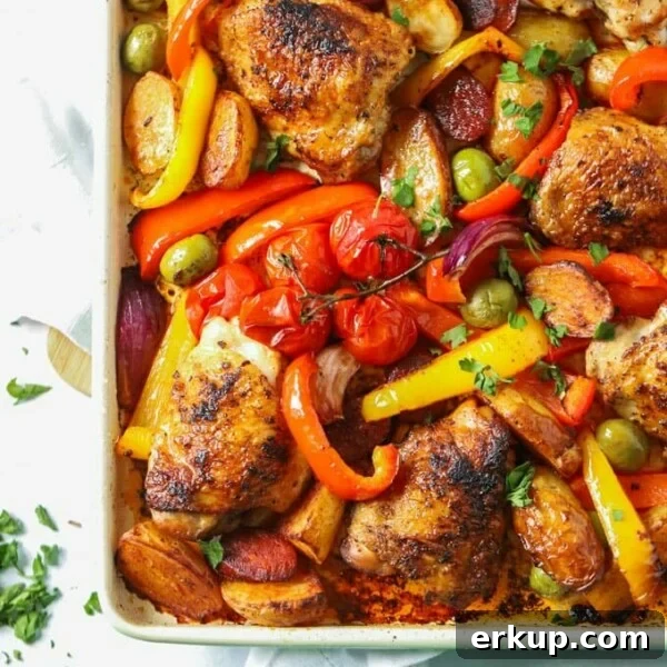 A tray of cooked Chicken and chorizo tray bake with roasted vegetables, ready to eat.