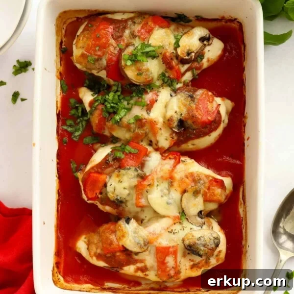 A baking dish with pizza topped chicken, ready to eat.