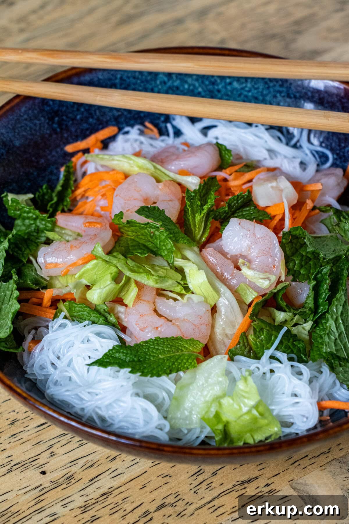 Close-up of Bun Tom salad with herbs