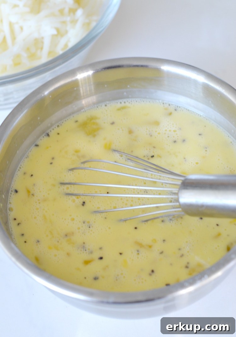 Whisking eggs in a bowl for hash brown bake
