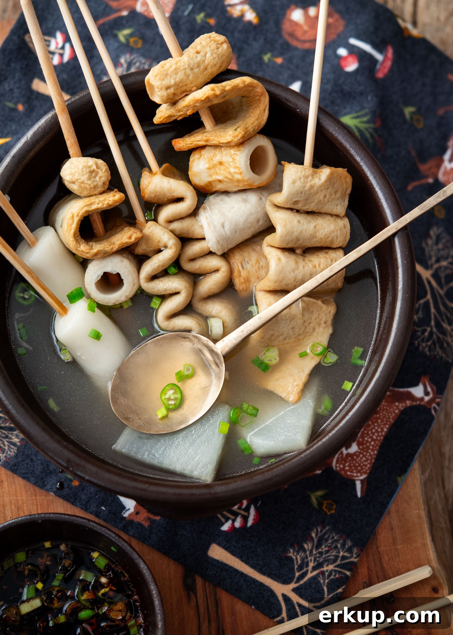 Clear broth from Korean fish cake soup showing a light, savory base
