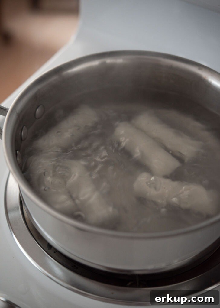 Rice cake logs boiling in hot water to soften