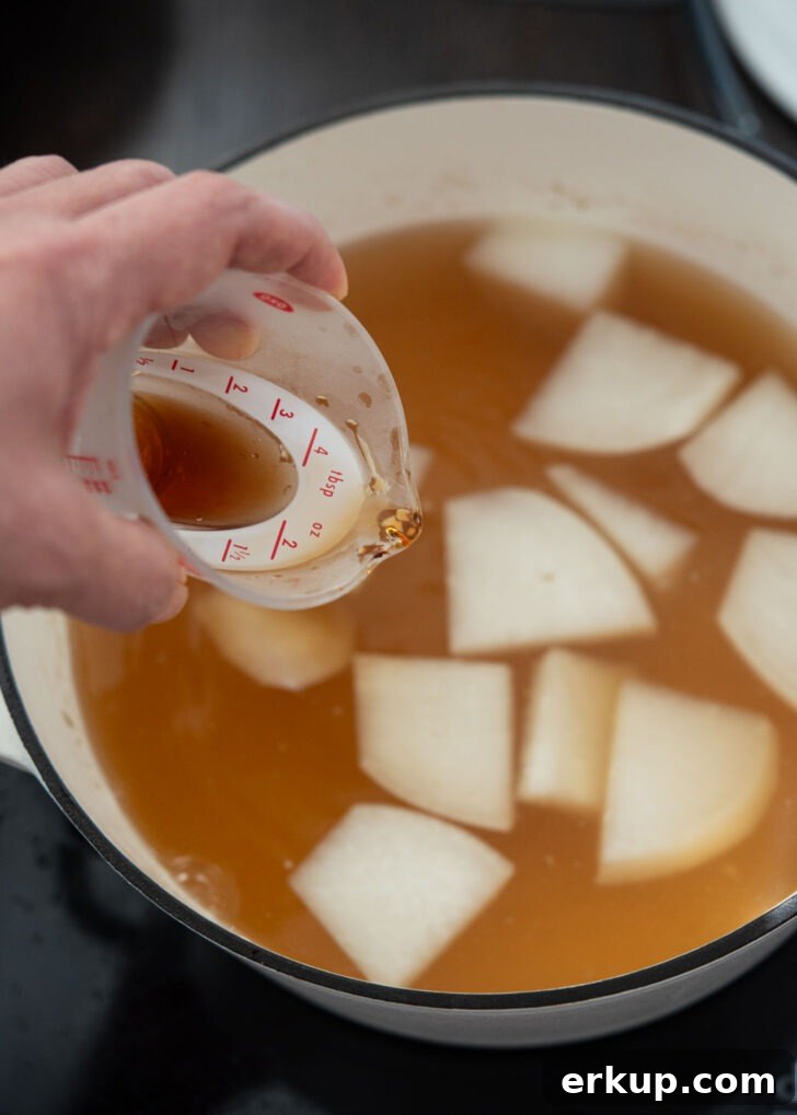 Seasoning the soup broth for savory depth.