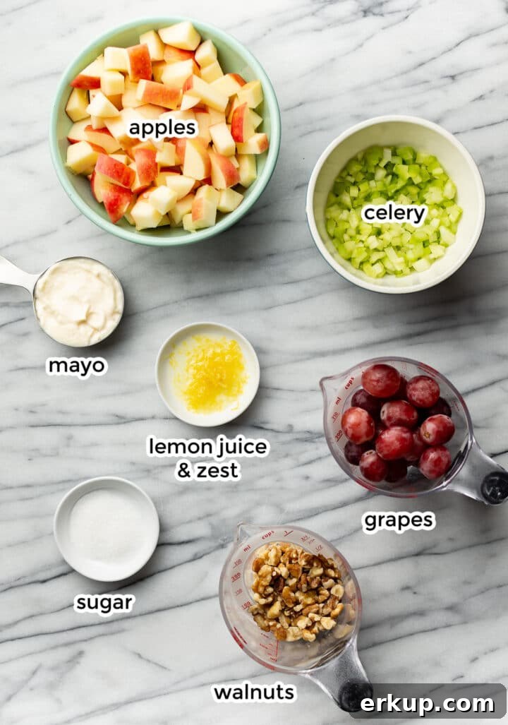 Ingredients for Waldorf salad on a marble counter