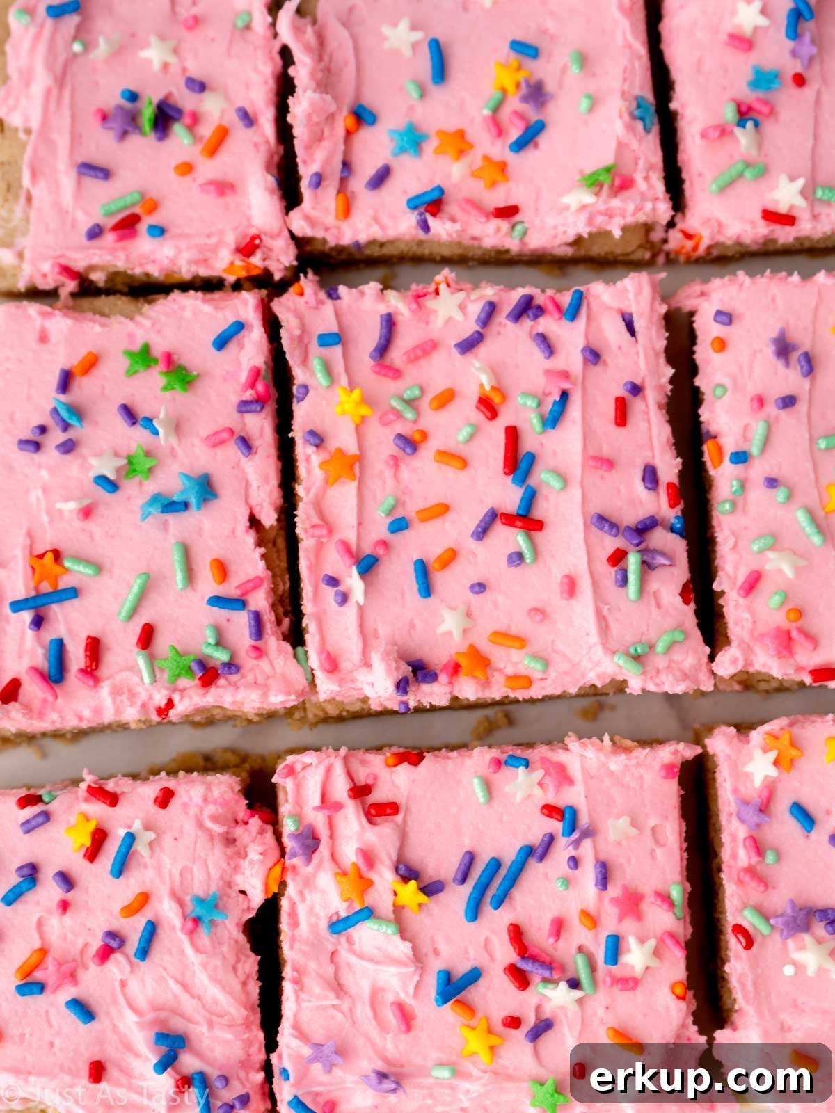Close-up of pink frosted sugar cookie cake bars.