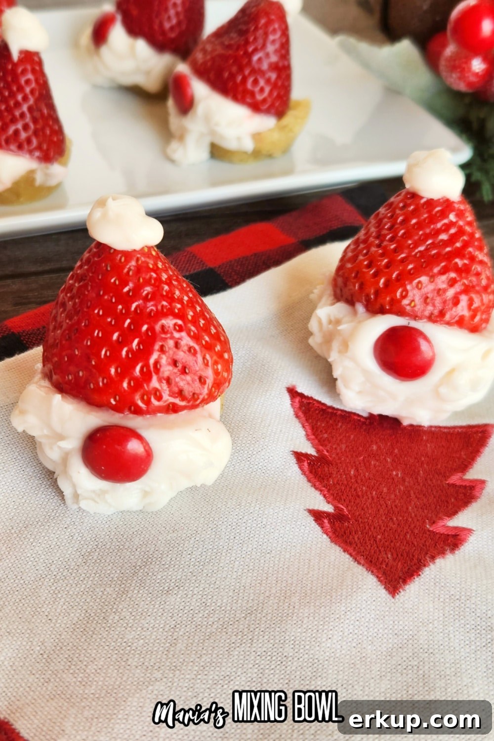 two santa gnome cookie cups on a Christmas napkin
